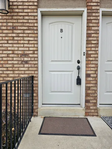 Doorway to property with brick siding