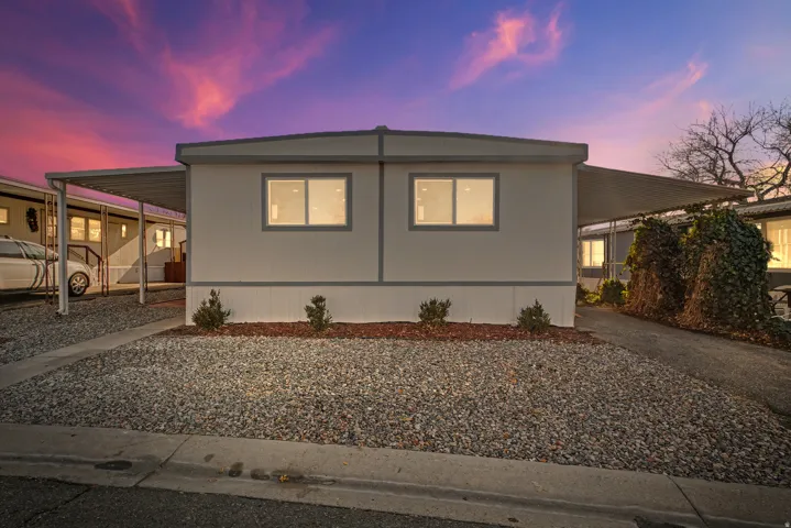 Manufactured / mobile home with a carport and driveway