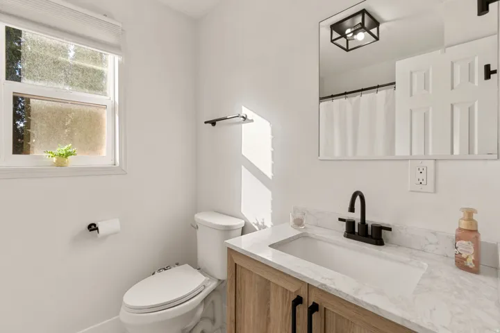 Full bathroom with a shower with shower curtain and vanity