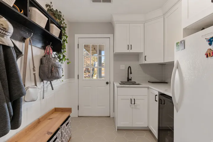 Mudroom featuring light tile patterned flooring and wainscoting