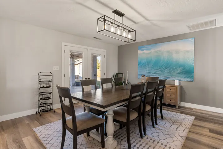 Dining room featuring french doors, wood finished floors, and a textured ceiling