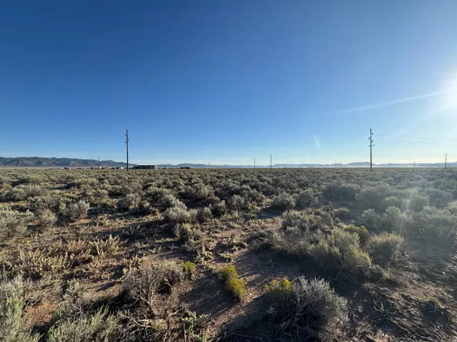 View of undeveloped land with a mountain backdrop