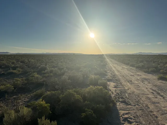 View of dirt / gravel road with a mountain view and a view of rural / pastoral area