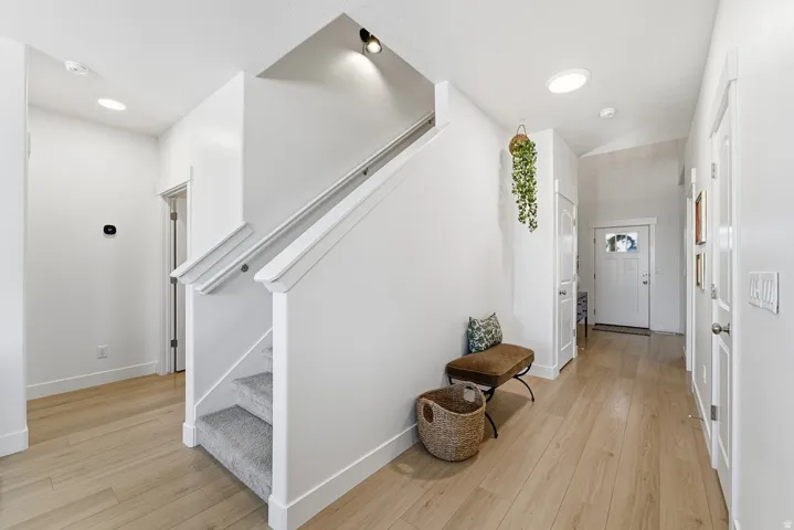 Foyer with stairs and light wood-type flooring