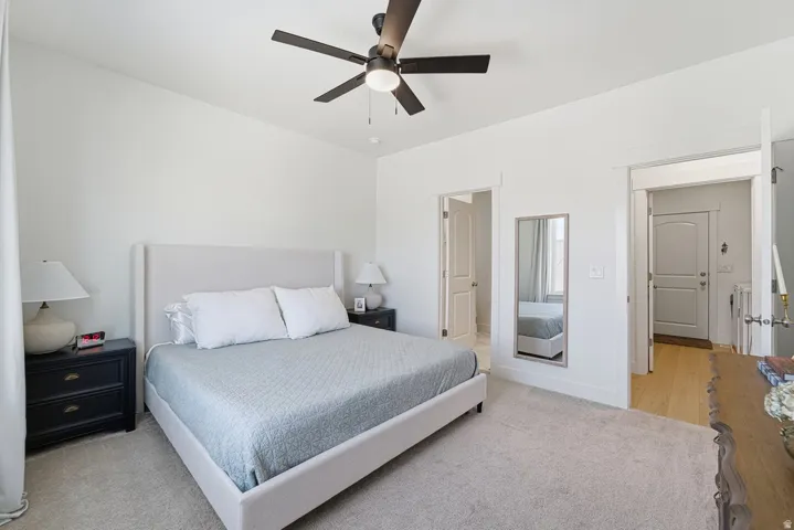 Bedroom featuring light colored carpet and a ceiling fan
