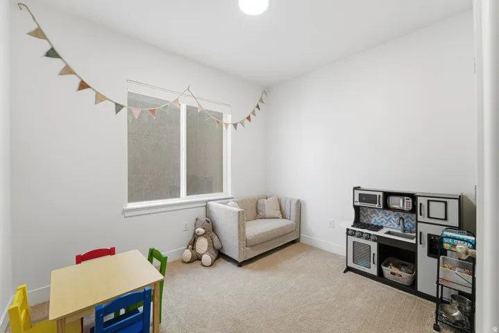 Playroom with carpet floors and baseboards