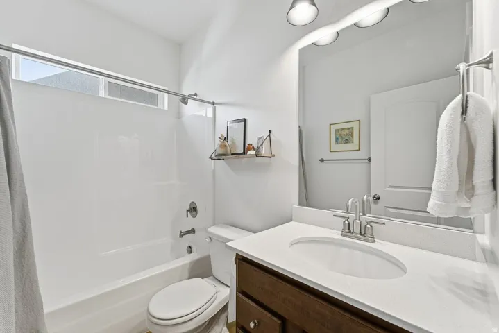 Full bathroom featuring vanity and shower / bath combination with curtain