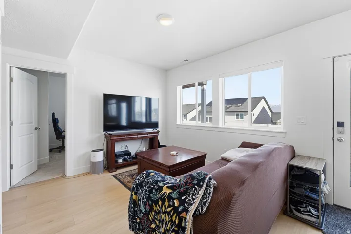 Living room featuring light wood-style floors and baseboards