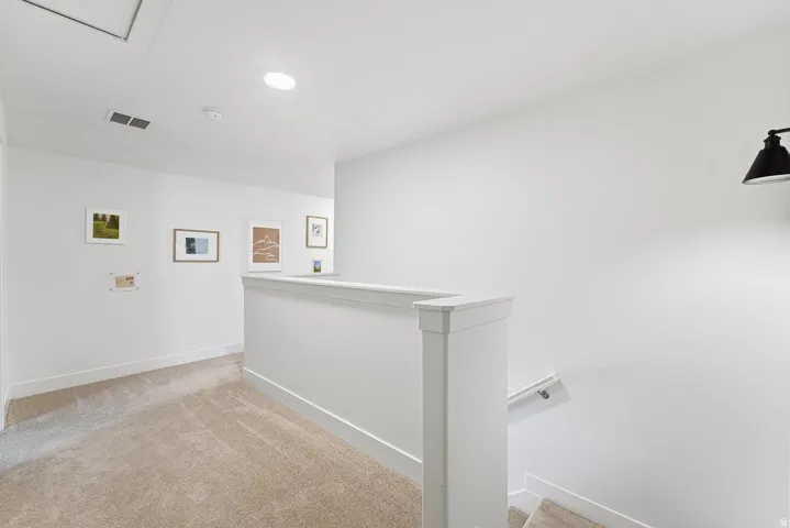 Washroom with light colored carpet and baseboards