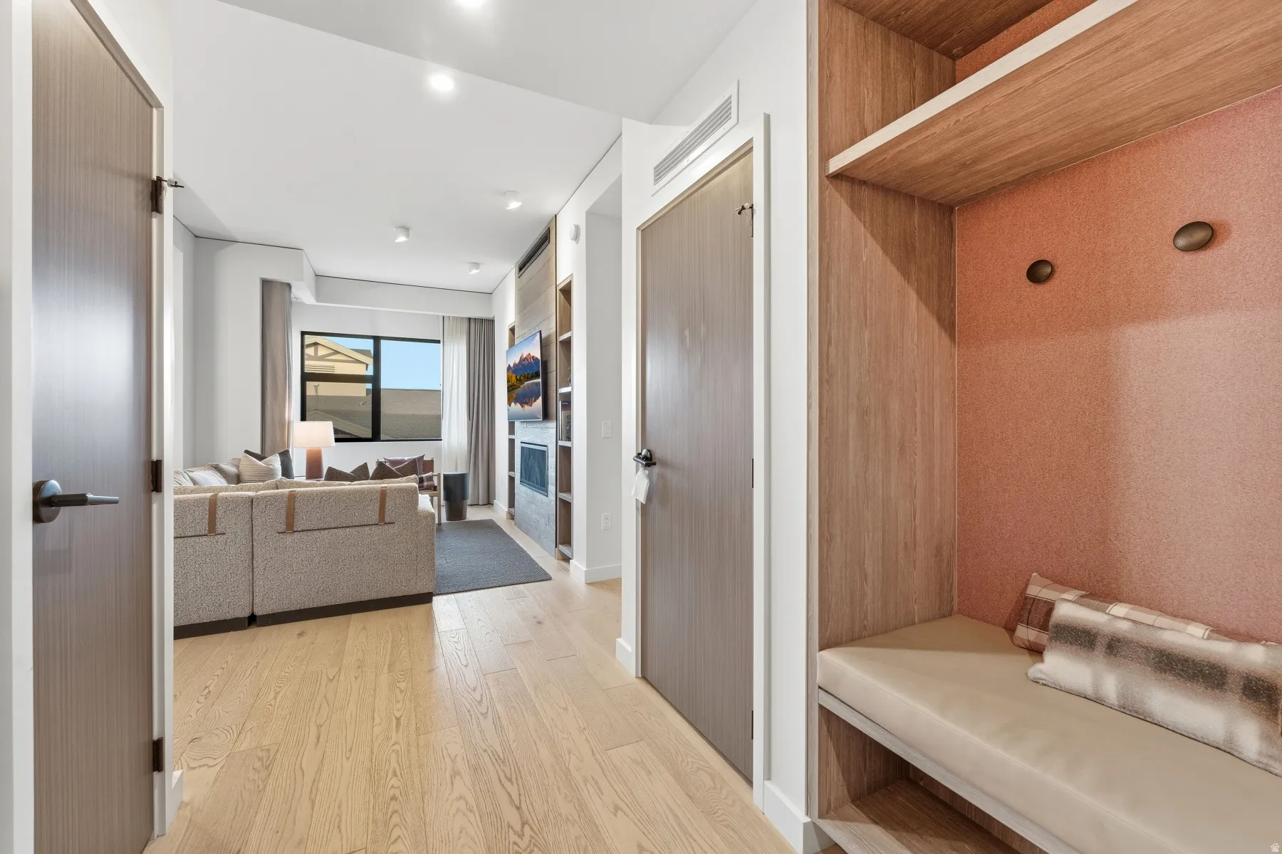Mudroom with light wood-style flooring and baseboards