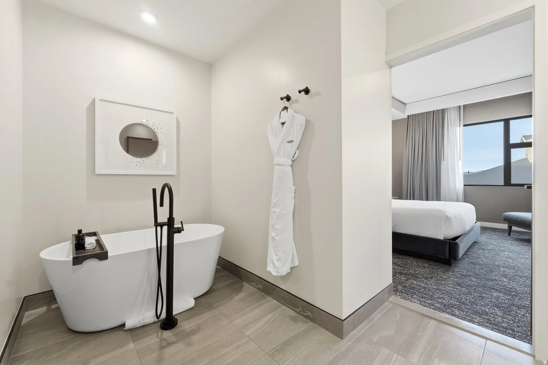 Ensuite bathroom featuring baseboards and a freestanding bath