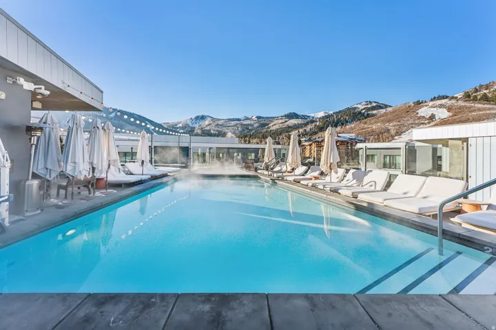 Community pool featuring a mountain view and a patio