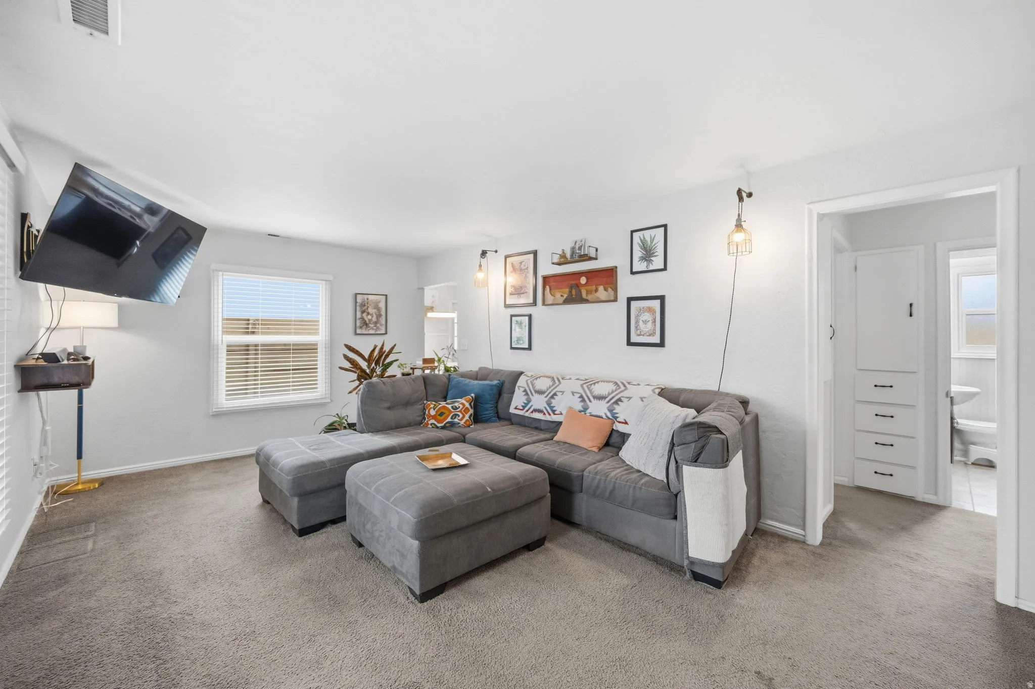 Carpeted living room featuring baseboards