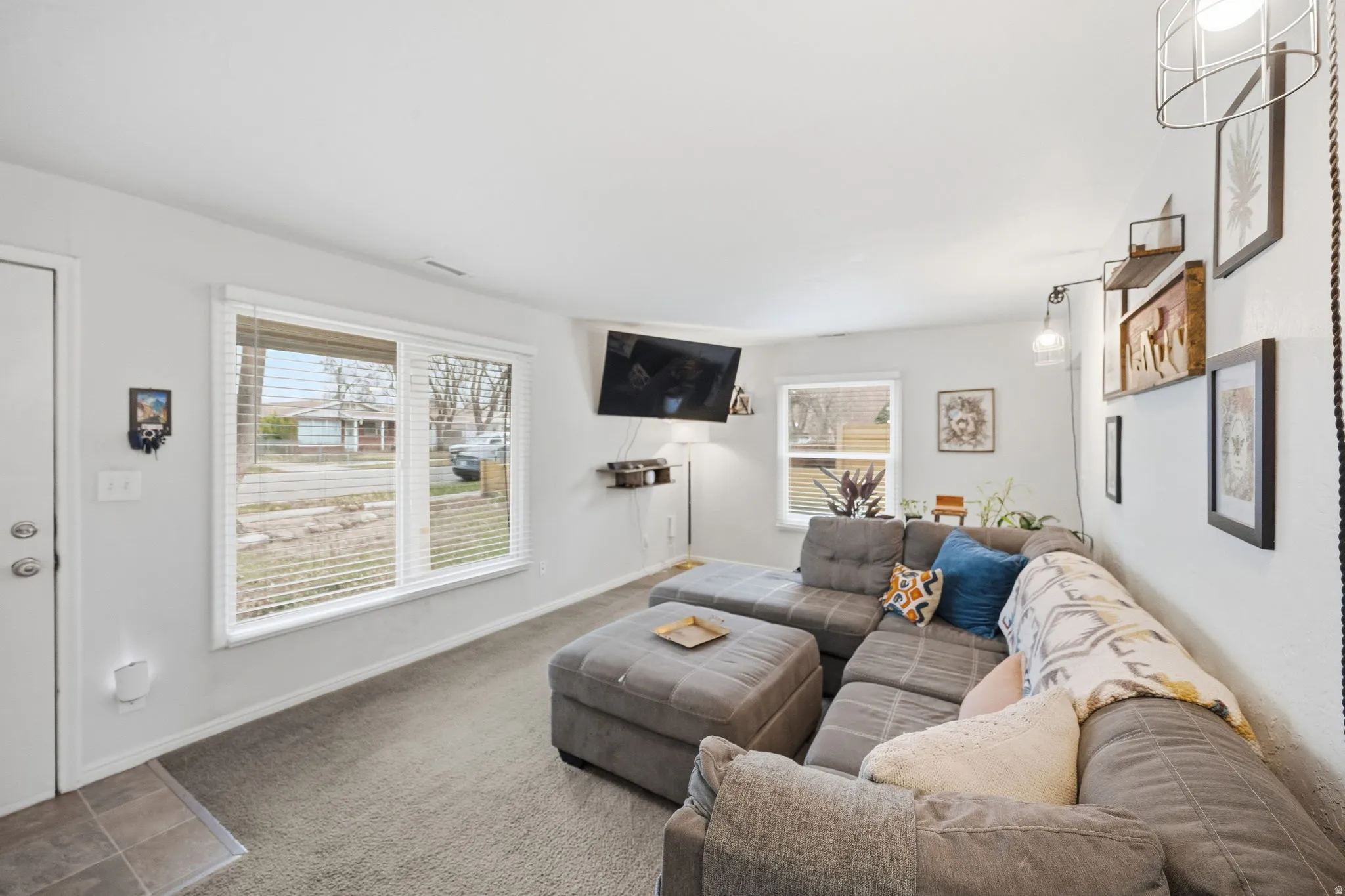 Carpeted living room featuring healthy amount of natural light