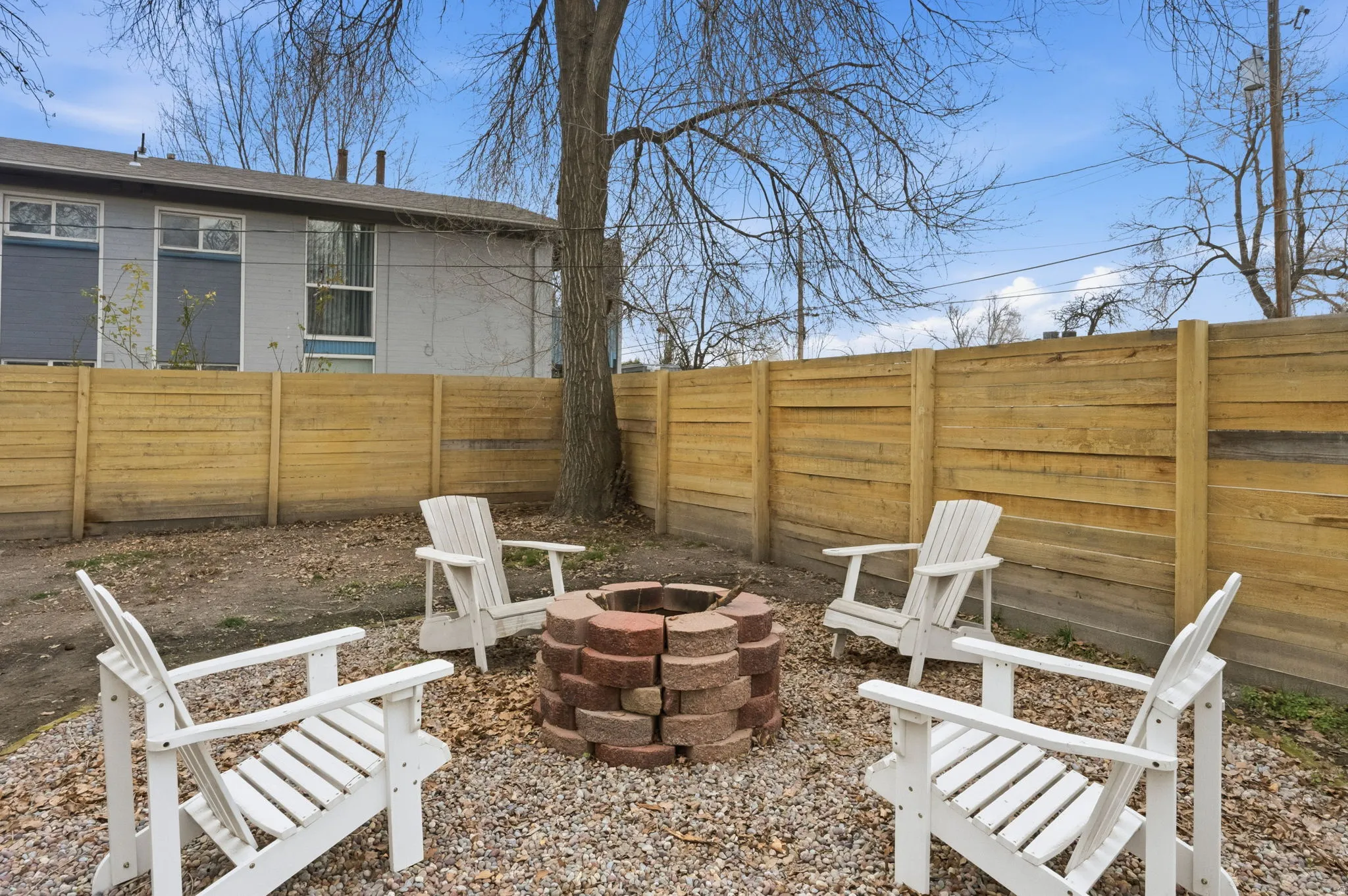 Fenced backyard featuring an outdoor fire pit