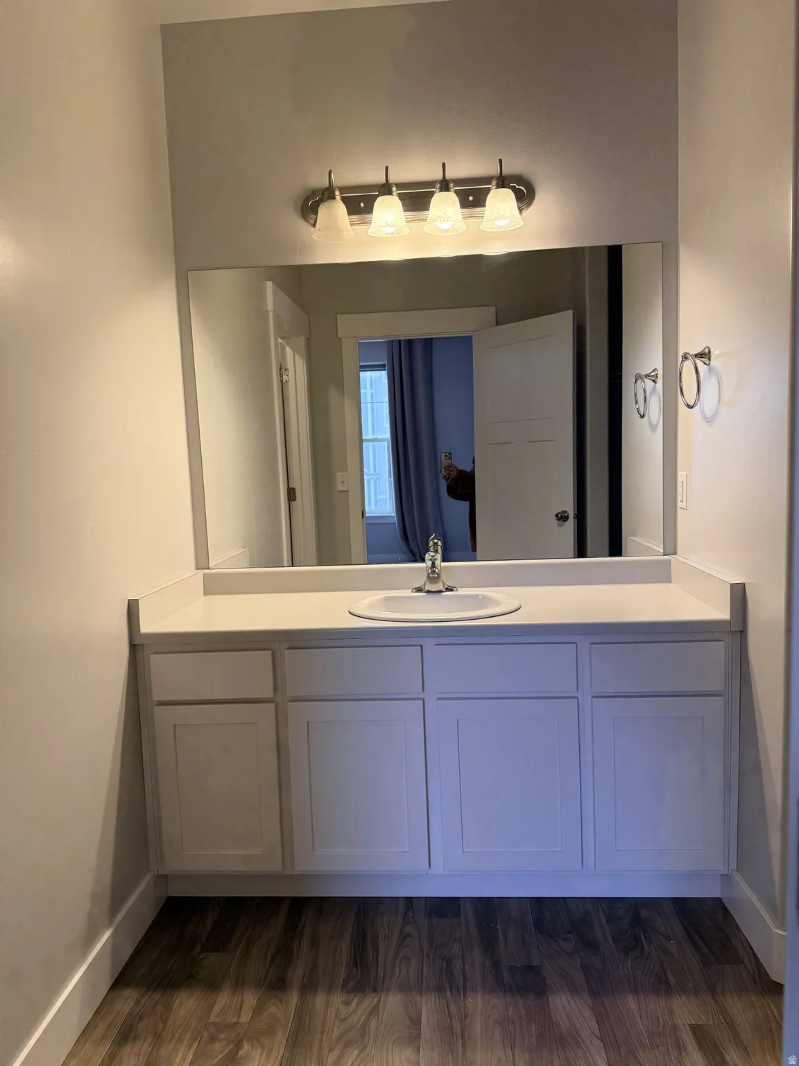 Bathroom with vanity and dark wood-style floors
