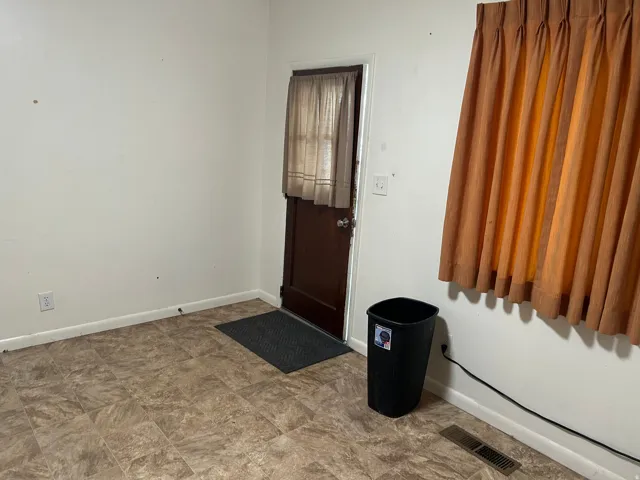 Foyer entrance featuring baseboards