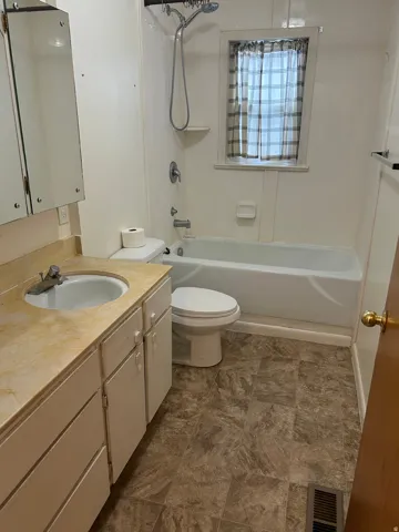 Bathroom with vanity and shower / bath combination