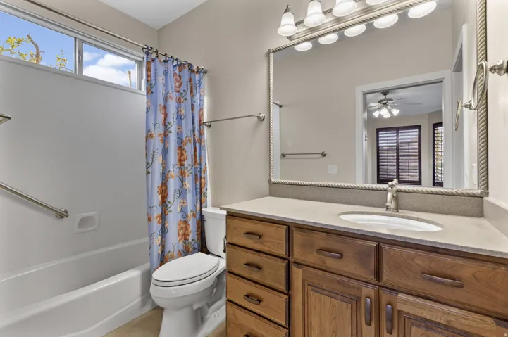 Casita full bath featuring shower / tub combo, vanity, and walk-in closet.