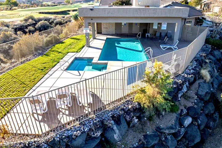 View of pool featuring a patio and a pool with connected hot tub.