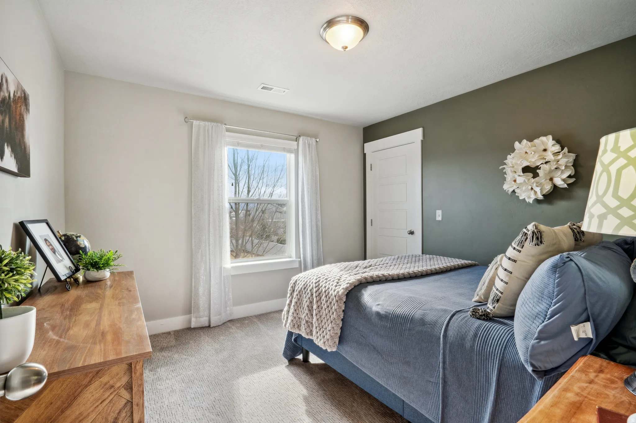 3rd bedroom featuring carpet floors and baseboards