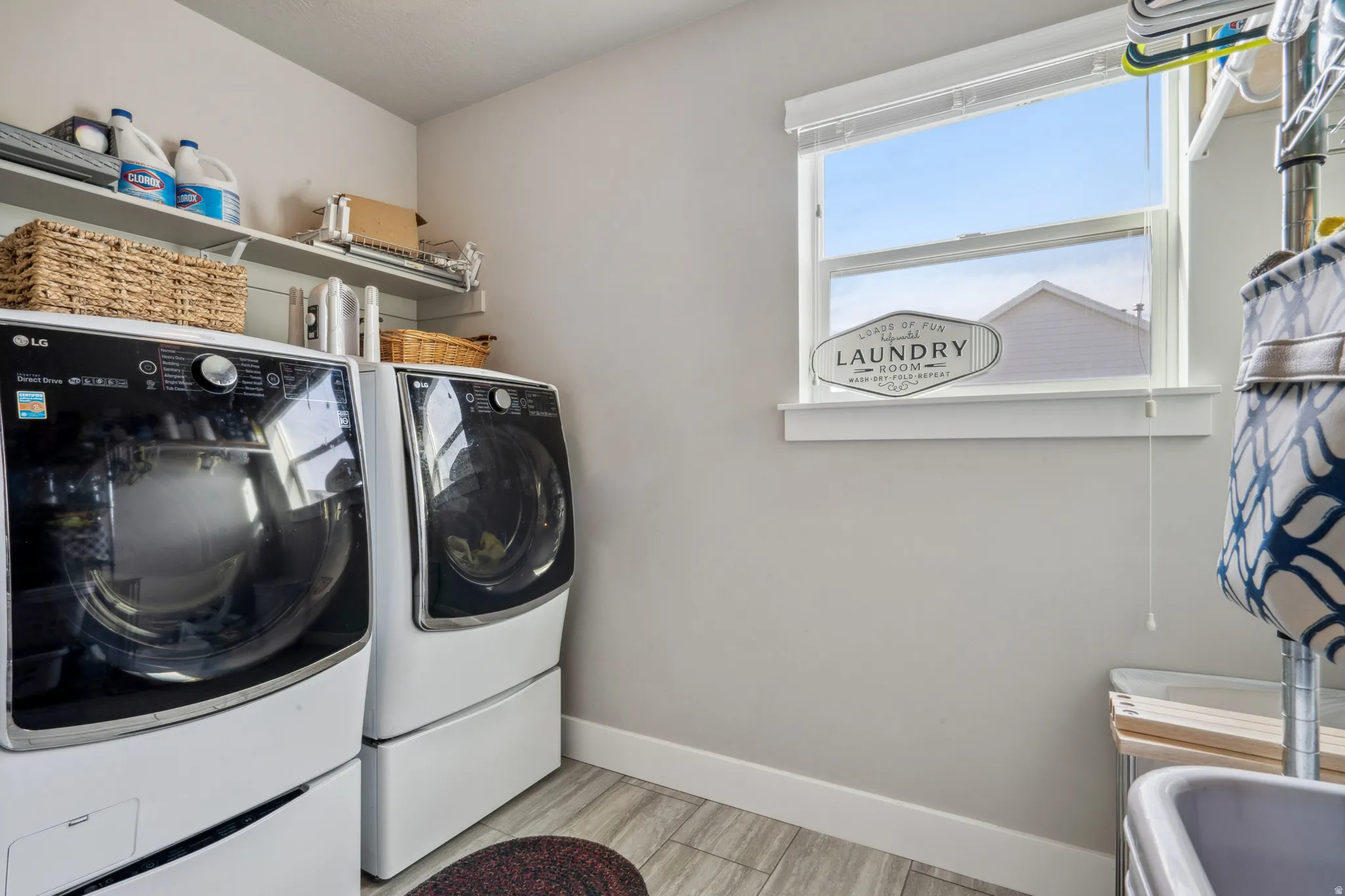 Laundry room featuring washing machine and dryer and wood finish floors