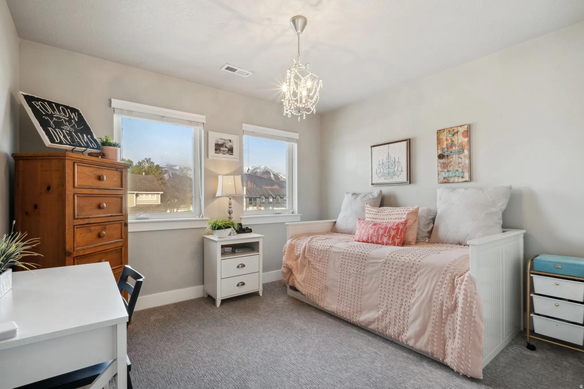 2nd bedroom with baseboards and a chandelier