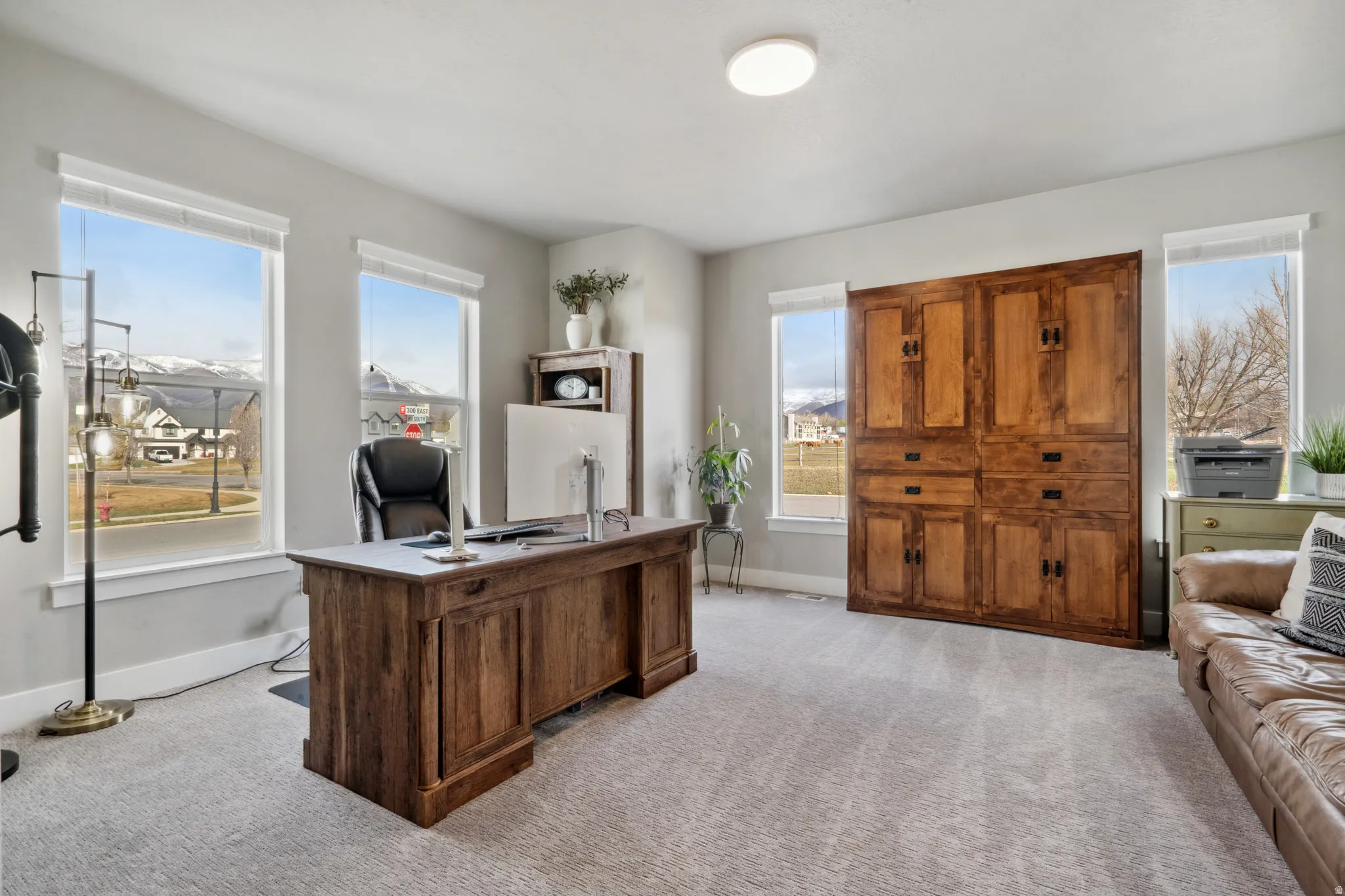 Home office with baseboards and light colored carpet