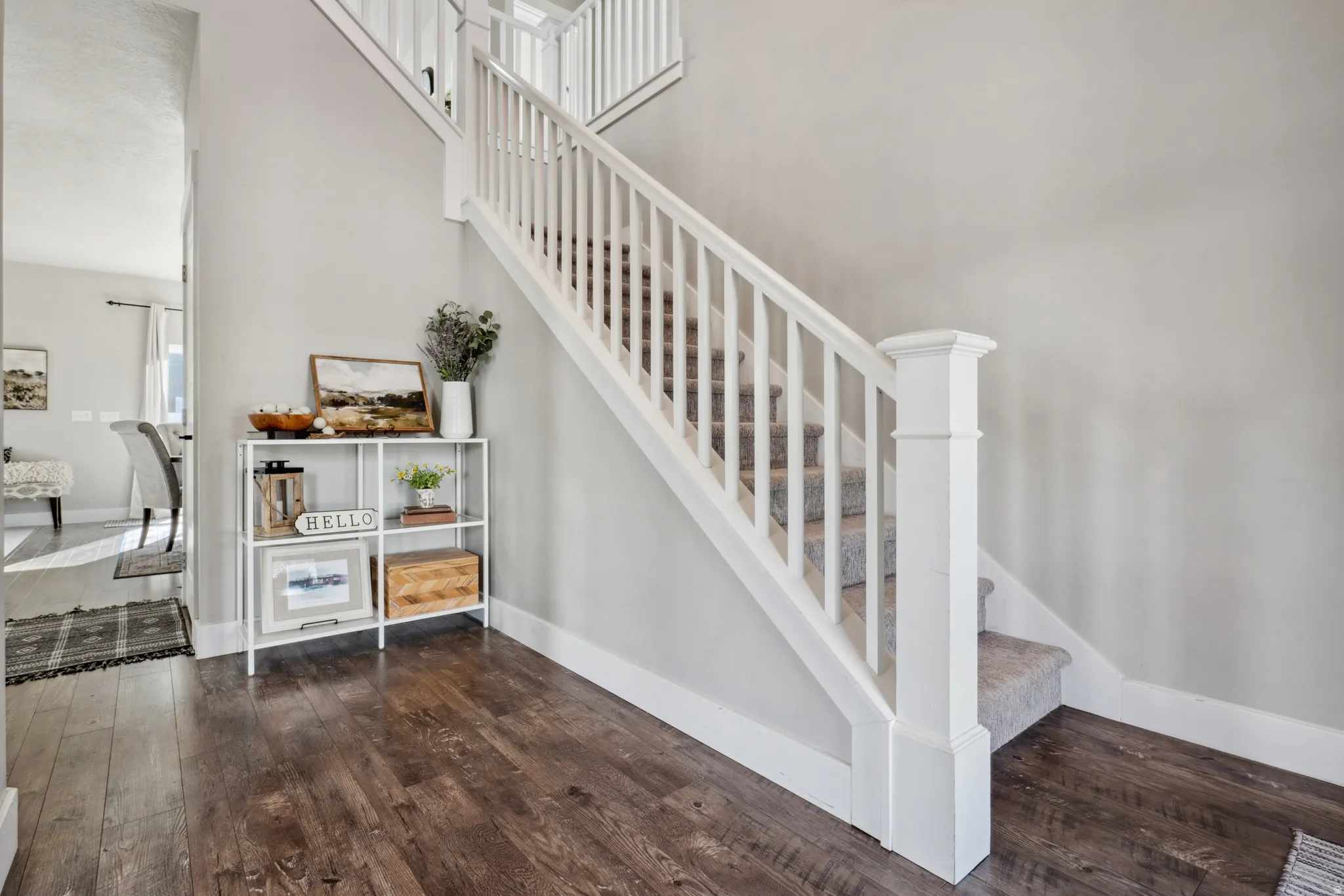 Entry with stairway with hardwood / wood-style flooring and a high ceiling