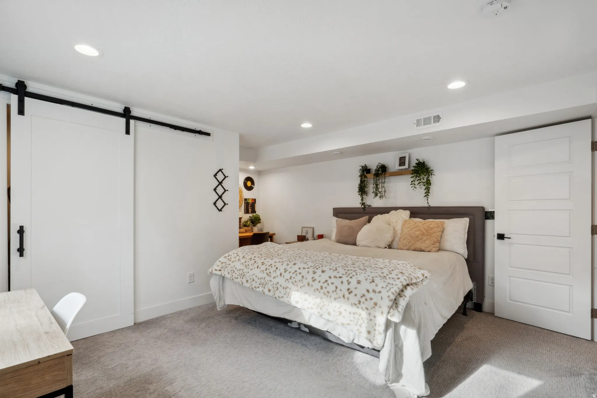 6th bedroom with a barn door and recessed lighting