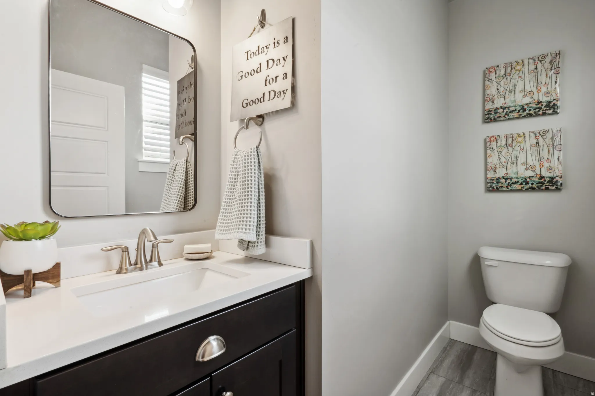 Half bathroom with vanity and light wood-type flooring