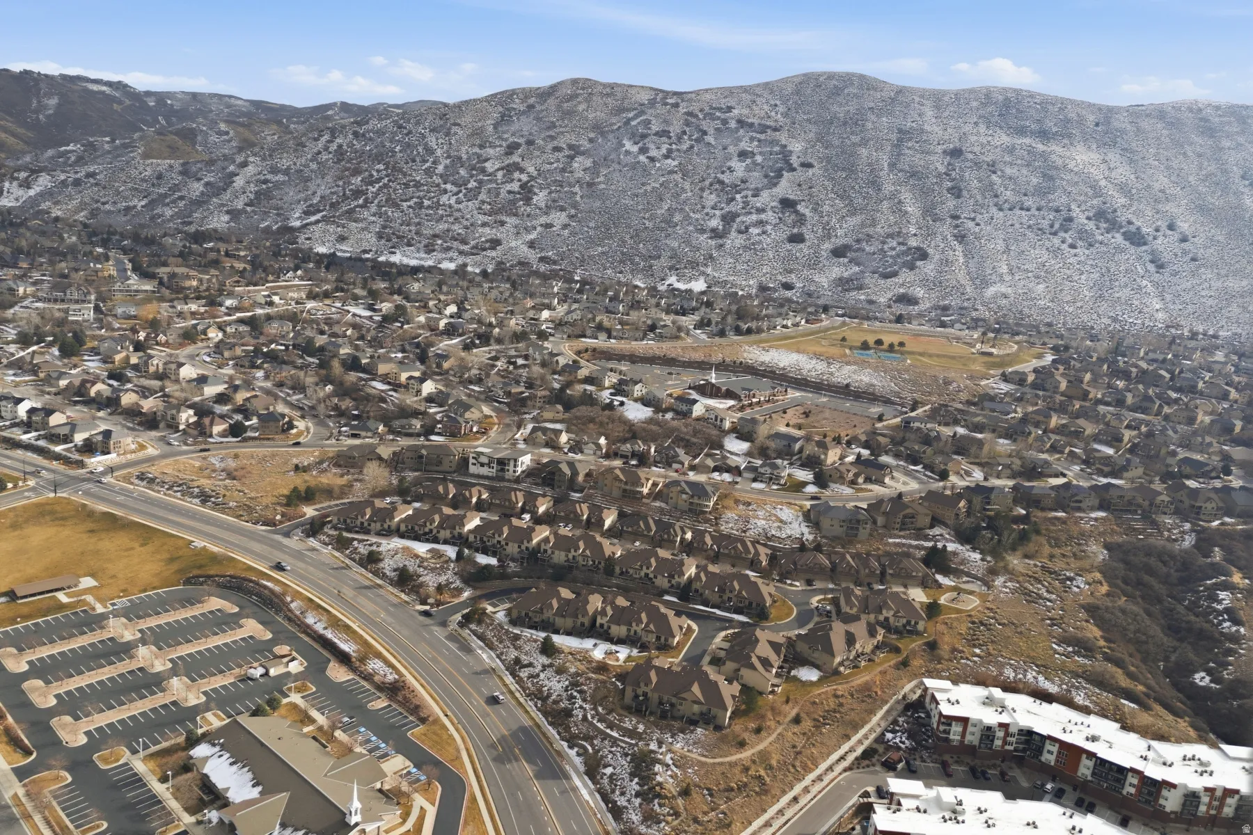 View of property location with a mountain backdrop and nearby suburban area