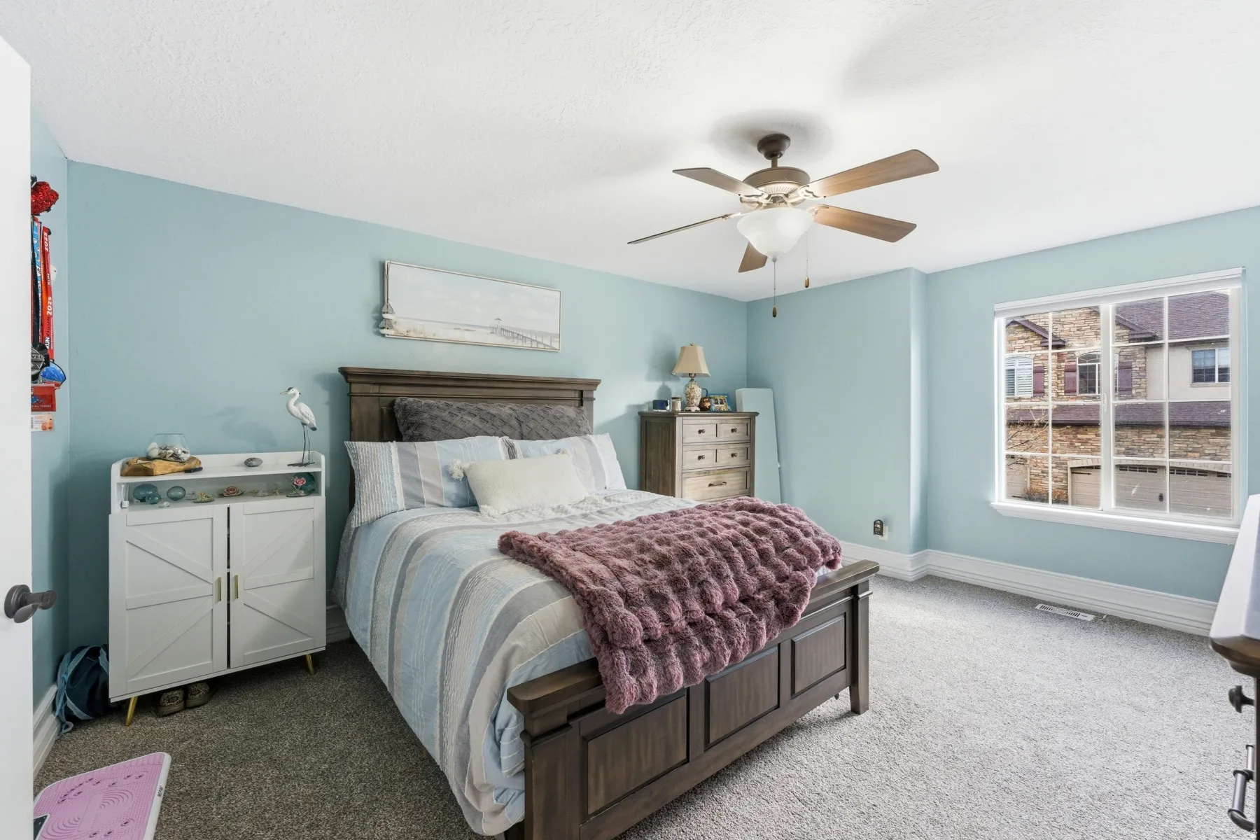 Carpeted bedroom with baseboards and ceiling fan
