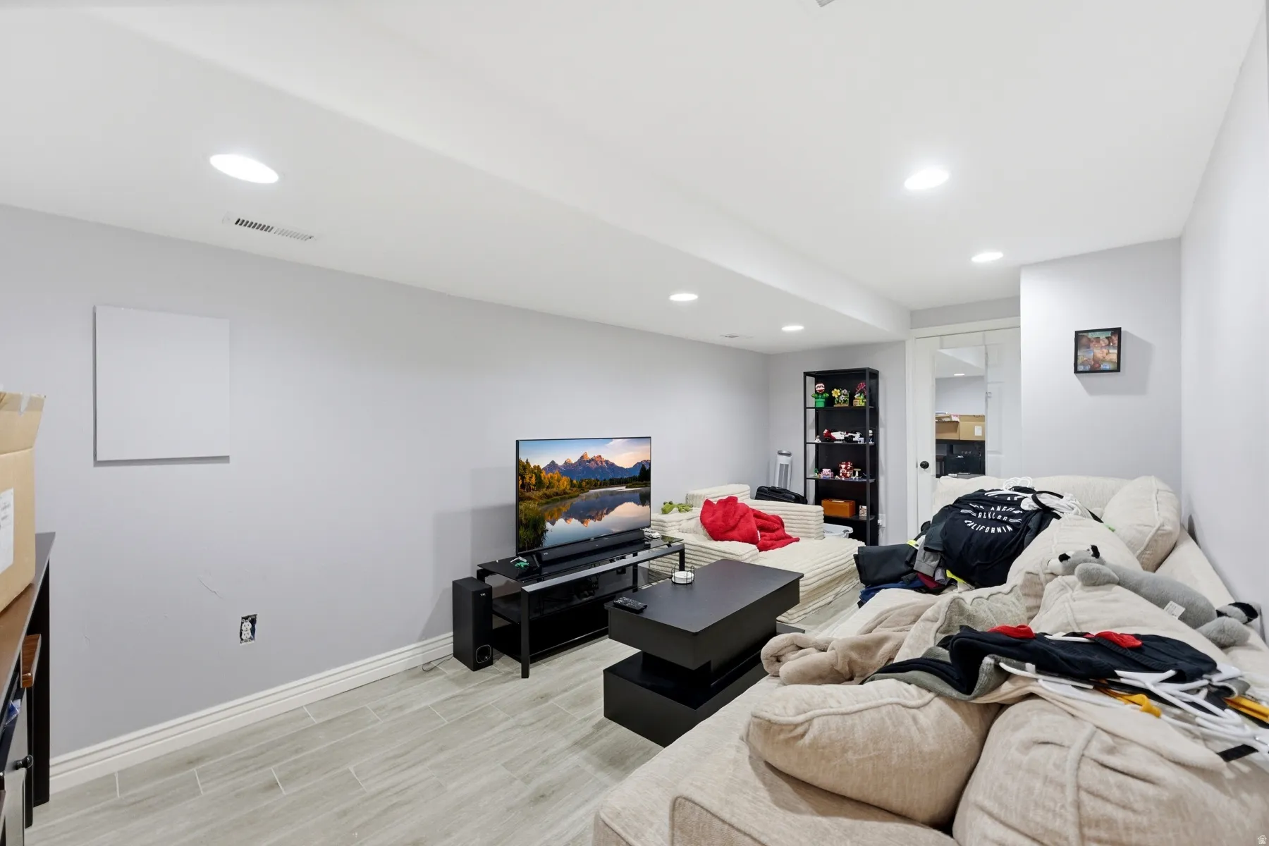 Living area featuring light wood-style flooring and recessed lighting