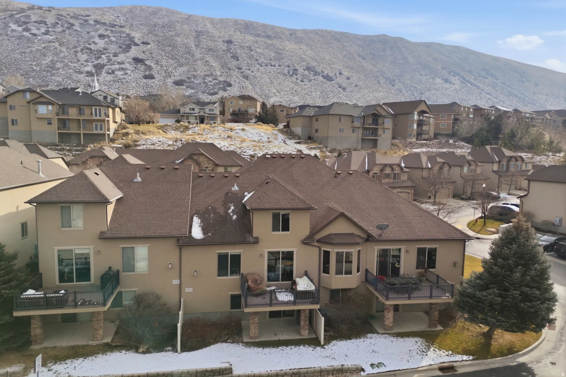 Snowy aerial view with a mountain view and a residential view