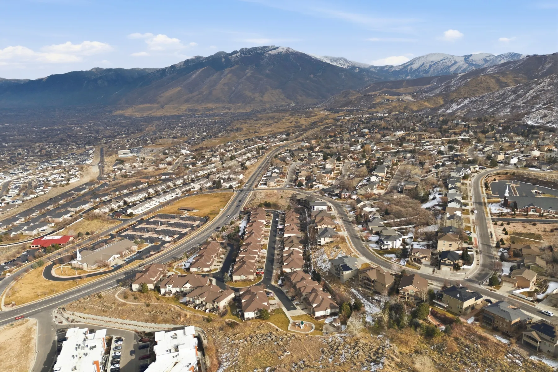 View of property location with mountains and nearby suburban area