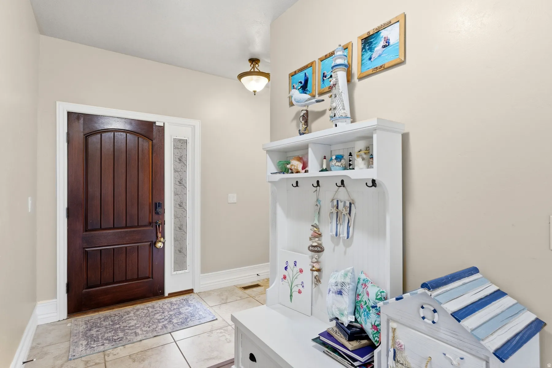 Mudroom featuring light tile patterned flooring and baseboards