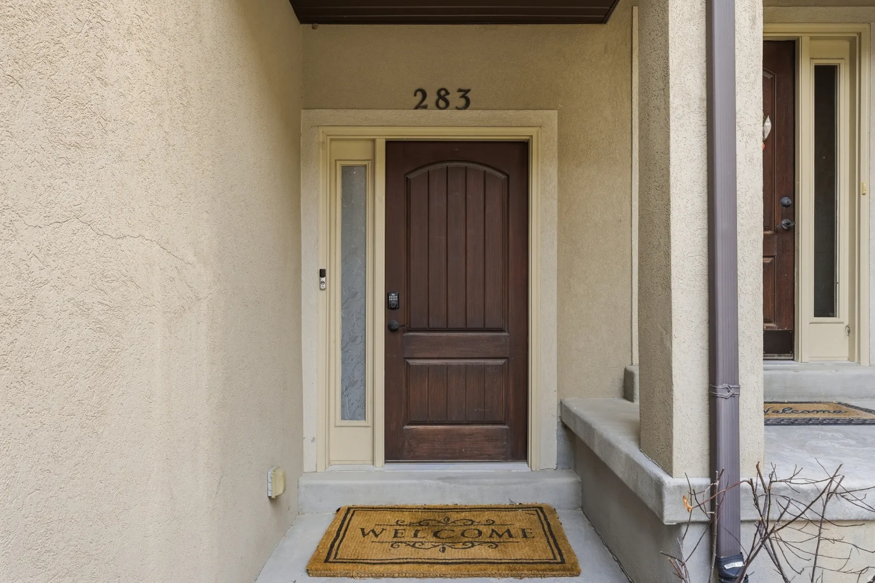 Doorway to property with stucco siding
