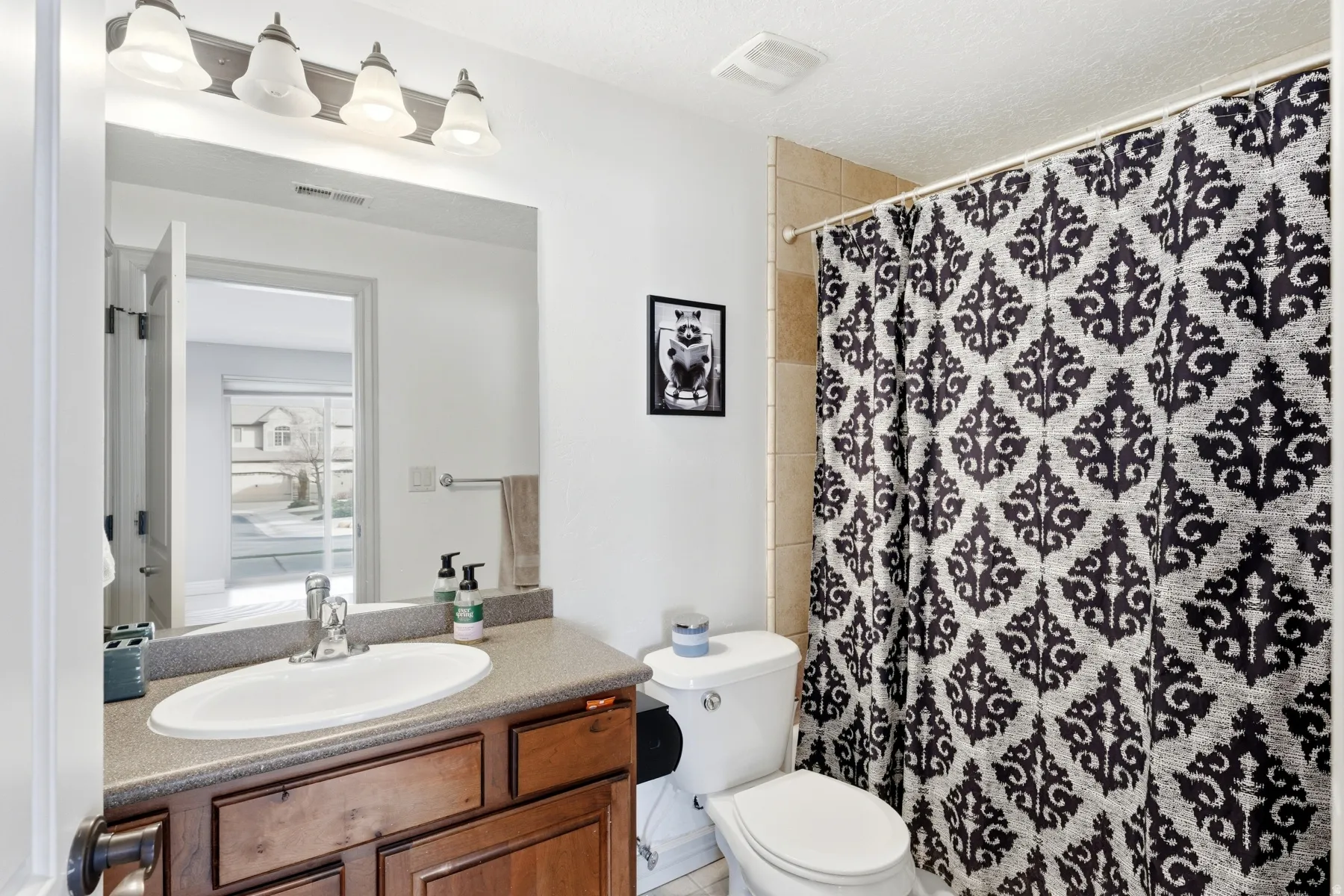 Full bath featuring a shower with shower curtain and vanity