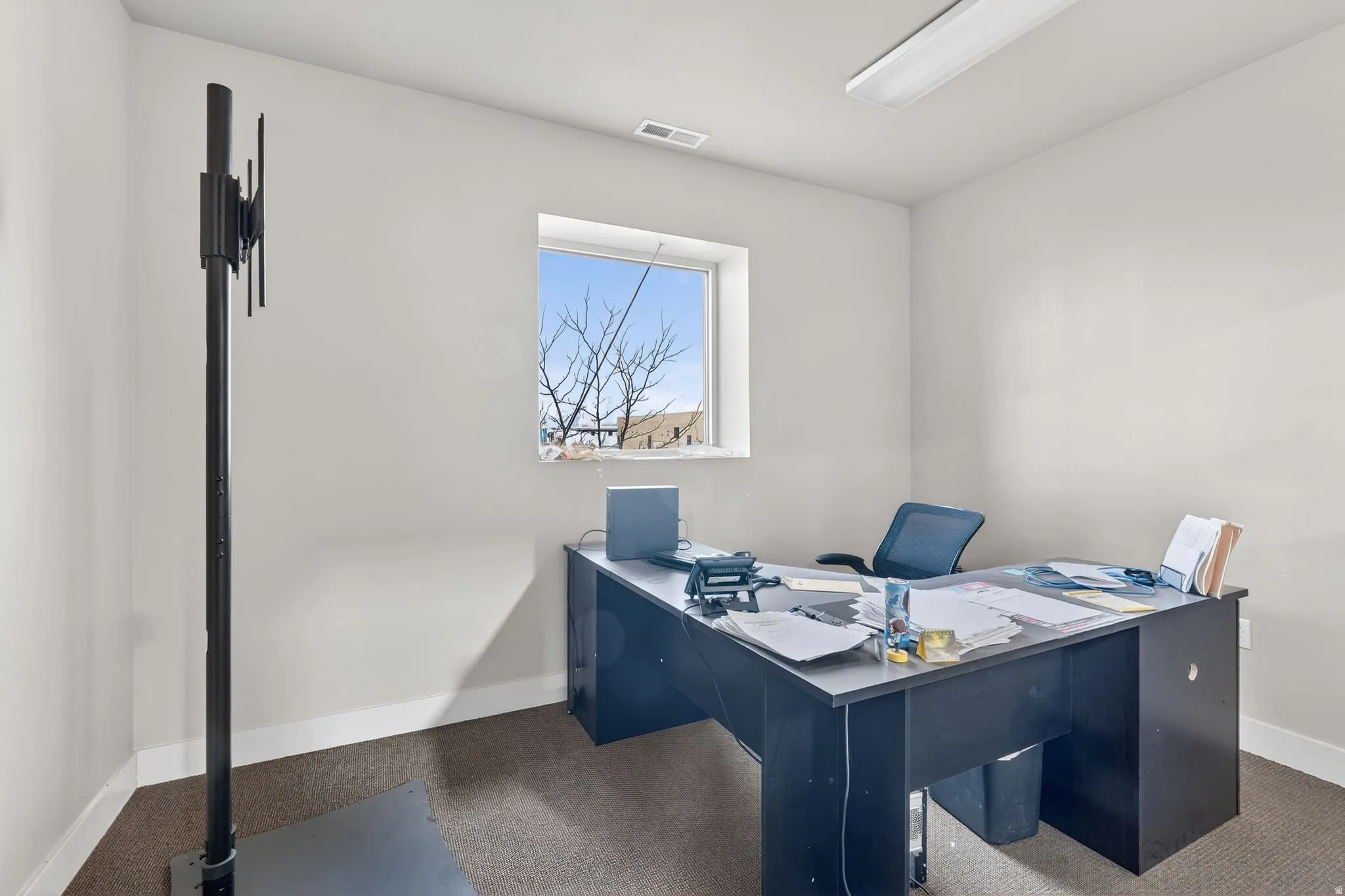 Carpeted office with baseboards