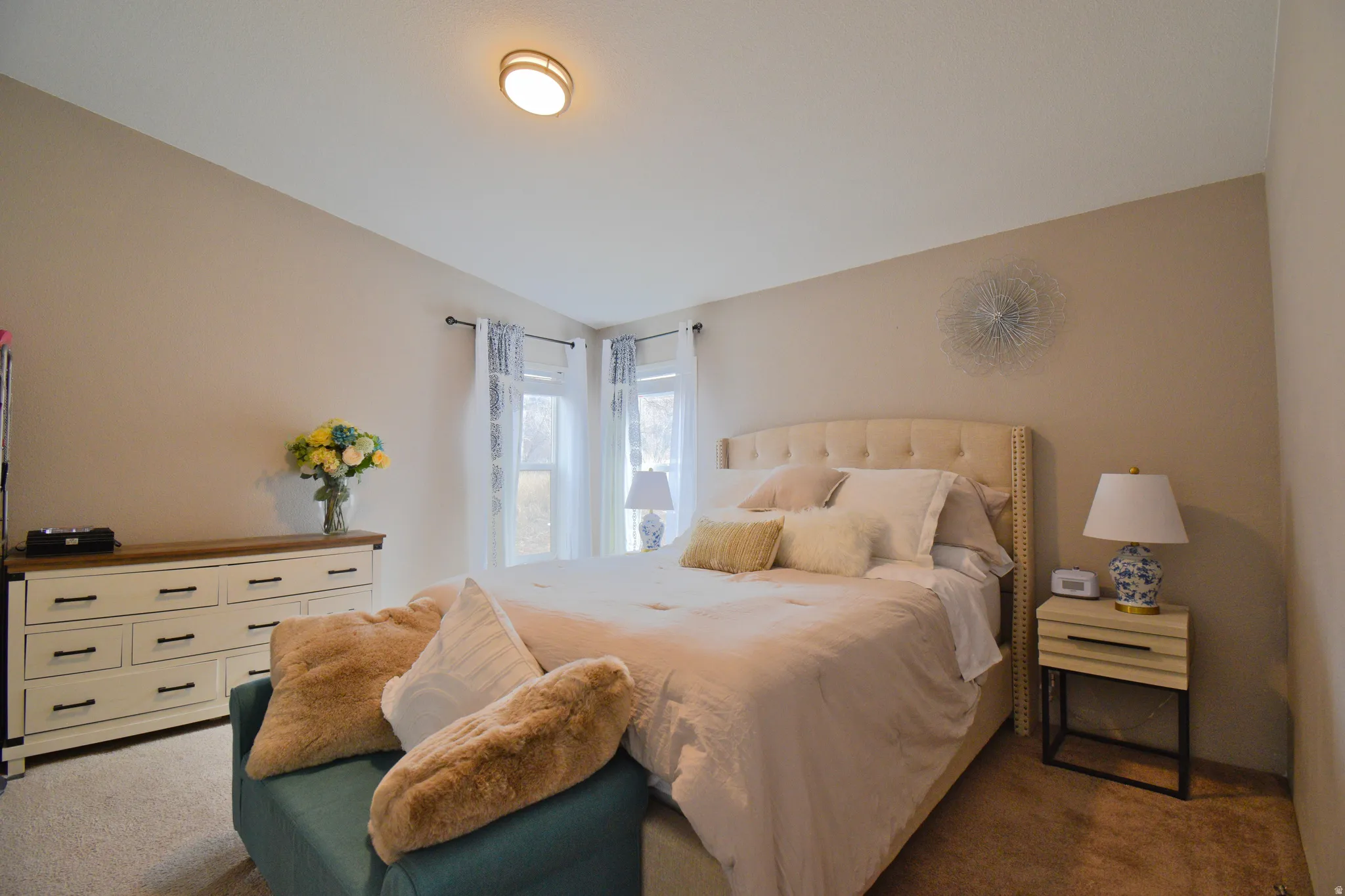 Primary Bedroom with carpet and vaulted ceiling