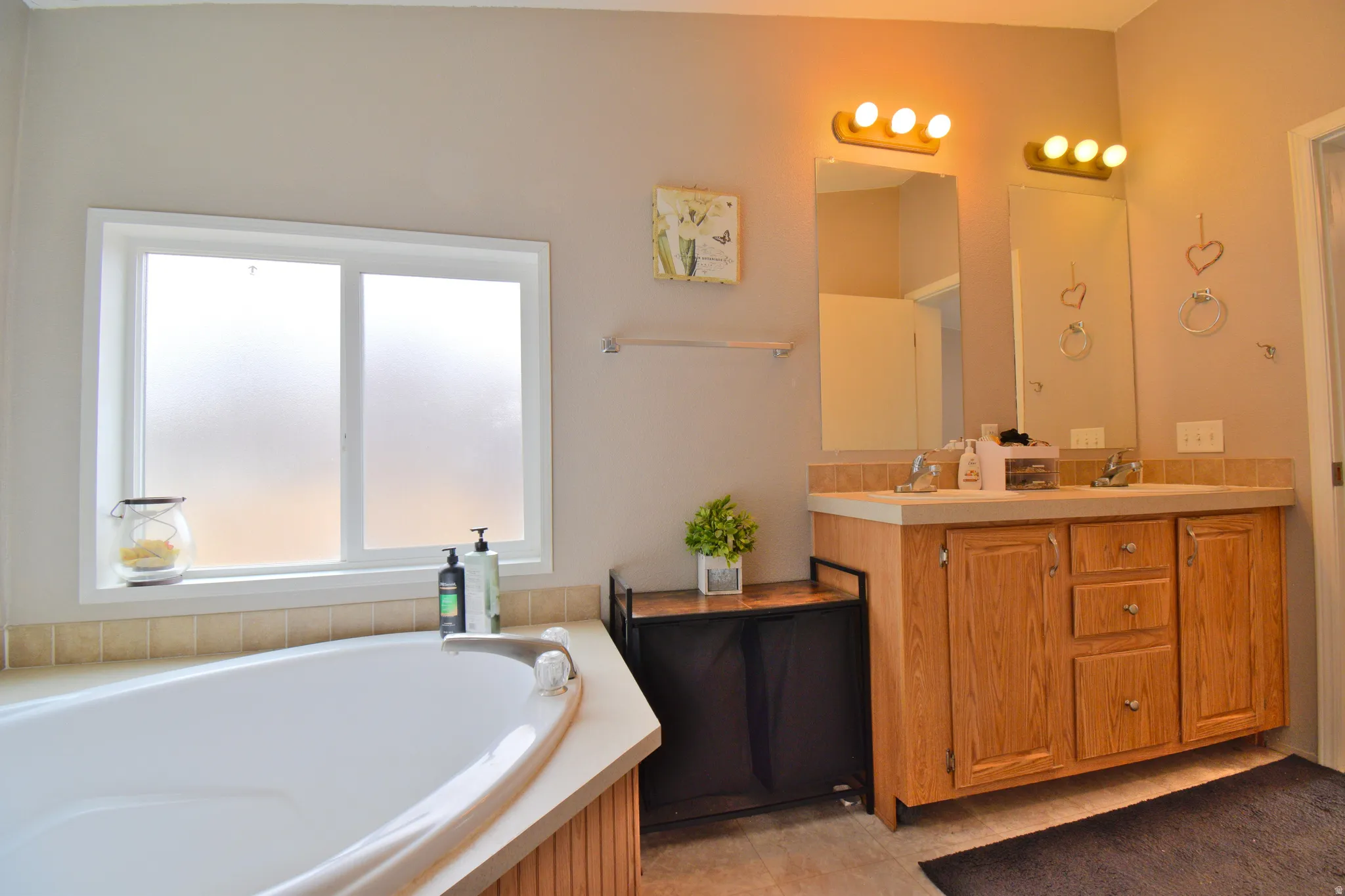 Full bathroom with double vanity and a garden tub