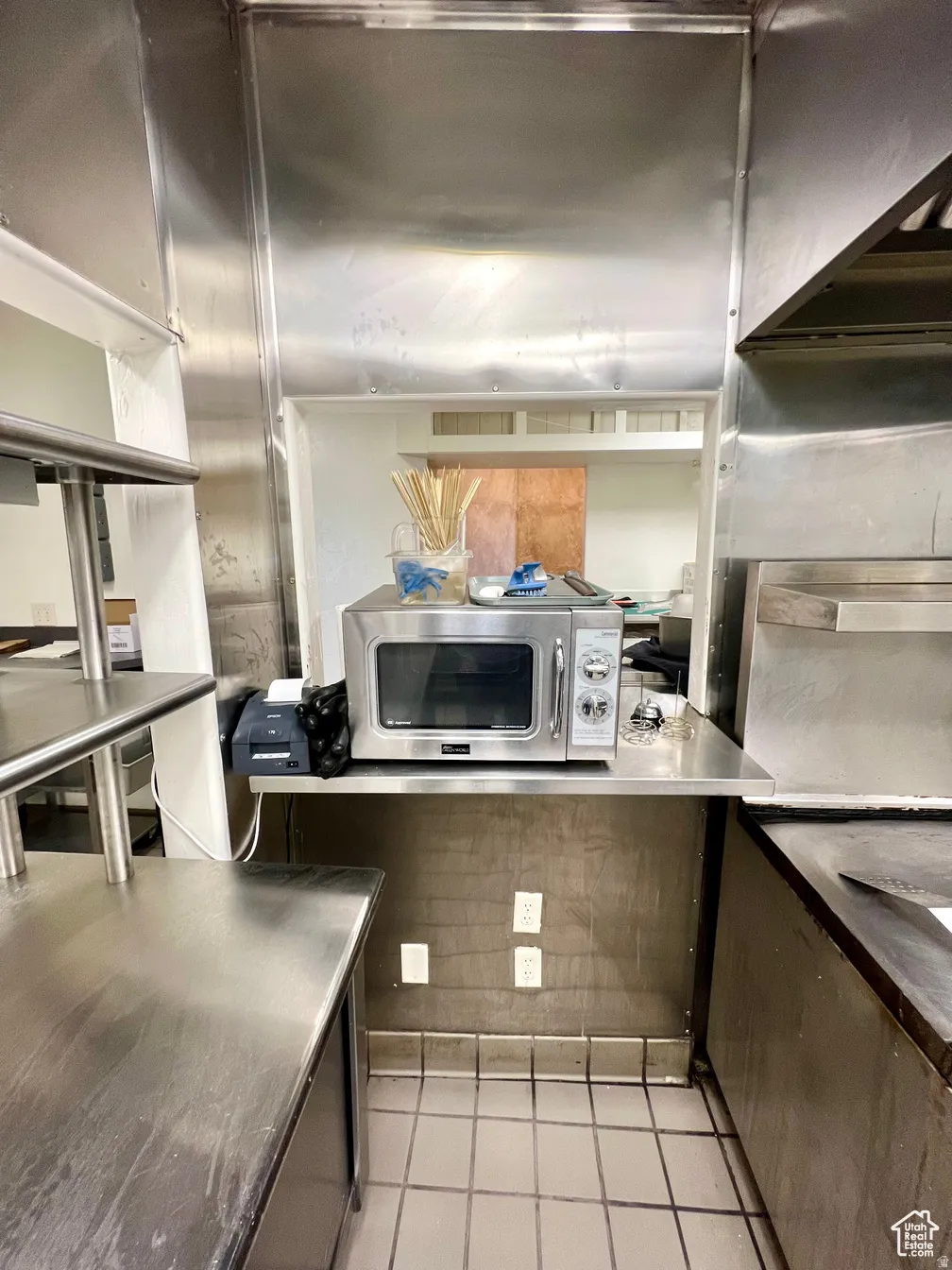 Kitchen with stainless steel microwave and stainless steel countertops