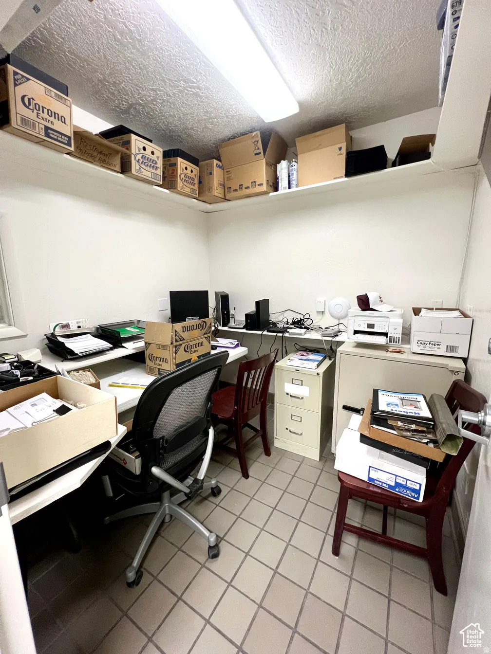 Office space with a textured ceiling and built in study area