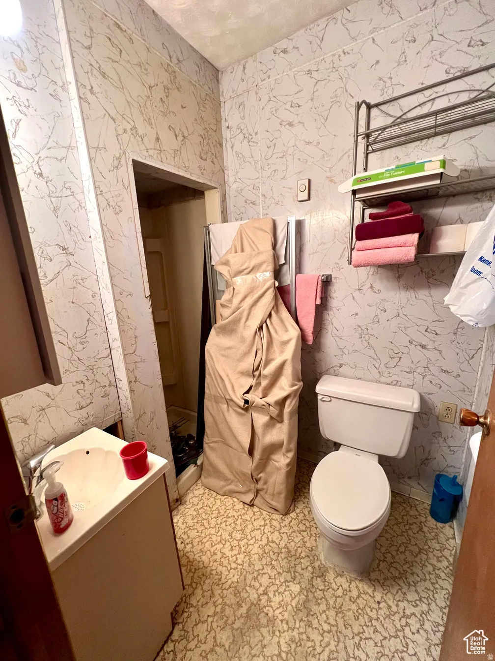 Bathroom featuring vanity and wallpapered walls