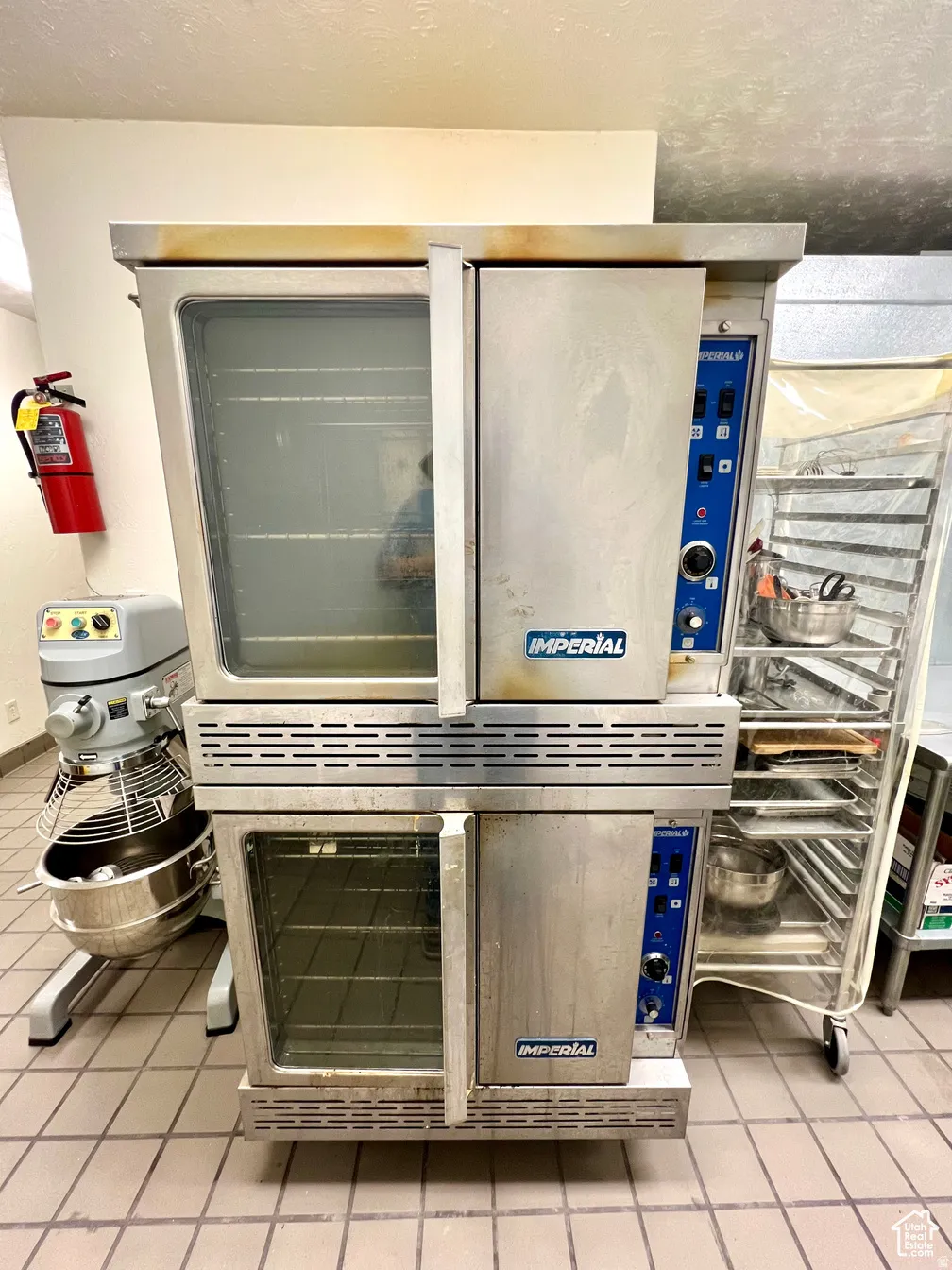 Detailed view of a fire extinguisher and a textured ceiling