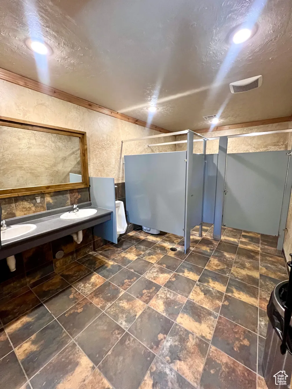 Below grade area with a textured ceiling and dark stone finish floors