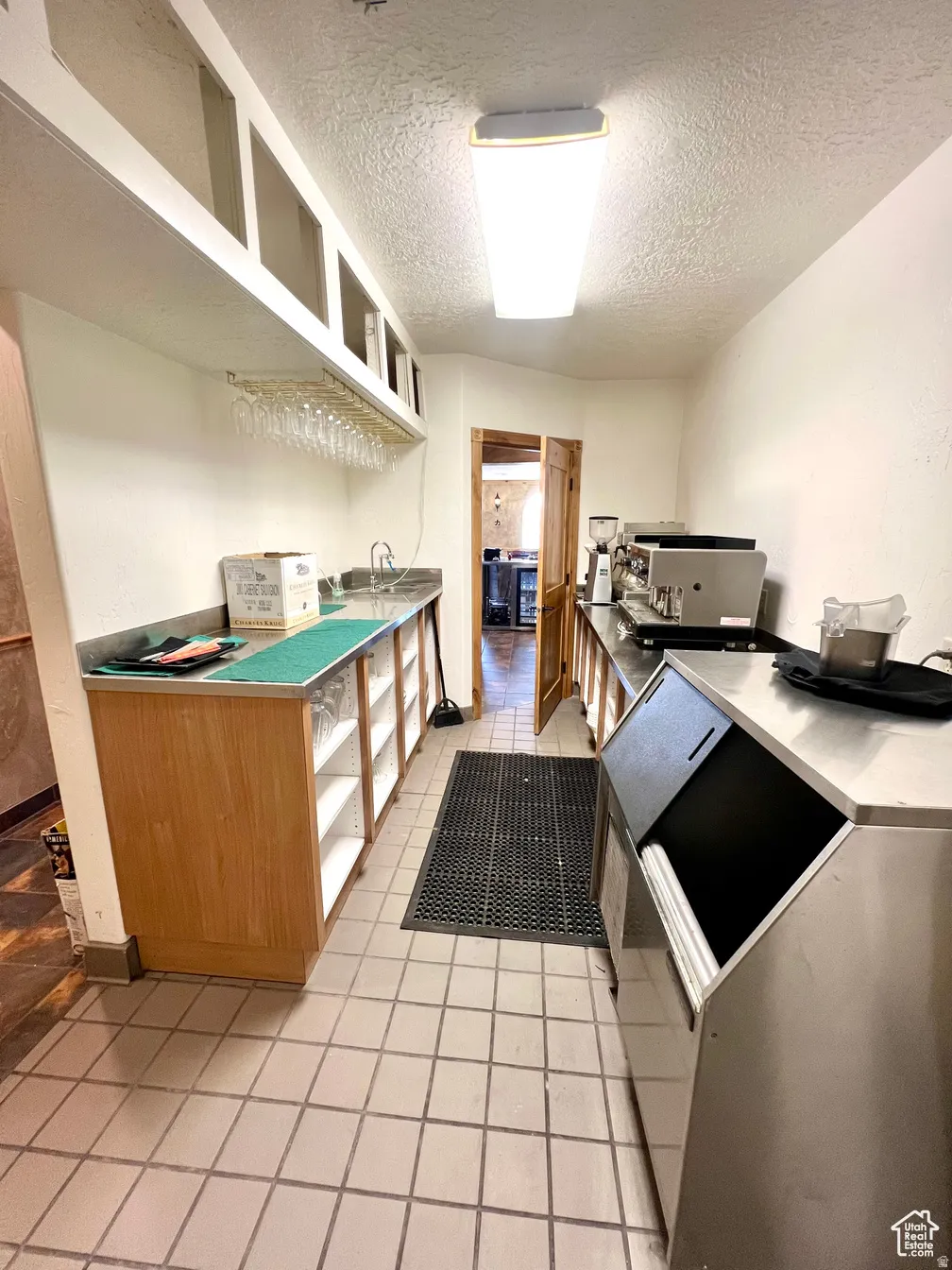 Kitchen with a textured ceiling and open shelves