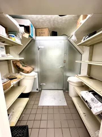 Full bath with toilet and a shower stall