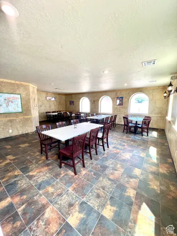 Dining room featuring a textured ceiling and recessed lighting